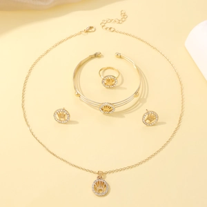 Golden jewelry set featuring crown emblem necklace, bracelet, ring and stud earrings