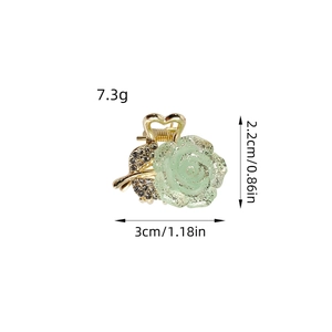 Elegant gold flower hair claw clip with green matte petals and sparkling leaf crystals