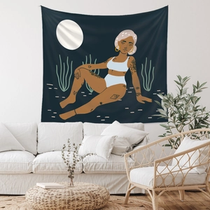 Artistic bohemian tapestry showing a woman under moonlight above a white sofa