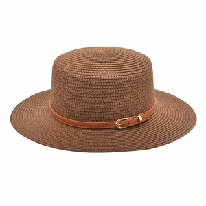 Detail of a brown straw flat top hat featuring a brown leather band and gold metal buckle