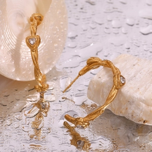Detailed shot of 18K gold plated hoop earrings with vine texture and heart zircon