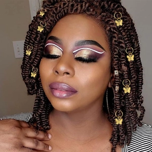 Golden butterfly pendant hair rings for dreadlocks shown on a model hairstyle