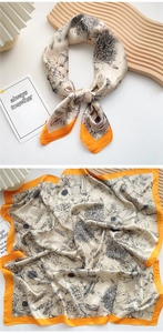 Detail of floral silk square scarf in beige and orange with daisy and polka dot patterns