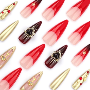 Red French gradient press-on nails with 3D chrome hearts and stiletto cross decorations