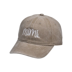 Close-up of white mimi embroidery on washed cotton twill khaki baseball cap fabric