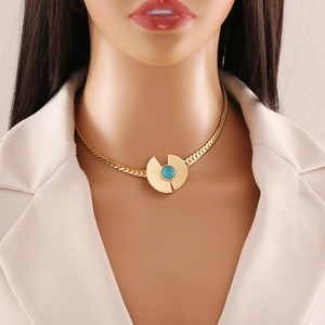 Gold flat snake chain necklace featuring a sunburst pendant with turquoise gemstone