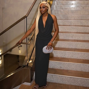Detail of elegant black halter neck jumpsuit with deep V-neck and draped fabric texture