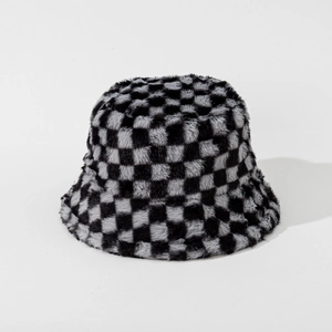 Close-up detail of plush checkerboard fisherman hat featuring soft faux fur texture