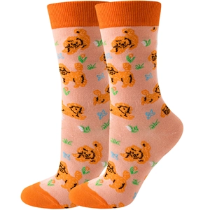 Detail of pink knitted socks with cute cartoon dogs and orange floral patterns