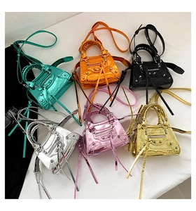 Flat lay of multiple metallic patent leather motorcycle bags in six vibrant colors