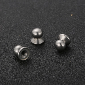 Macro shot of stainless steel bell-shaped hardware with internal thread and gun black finish