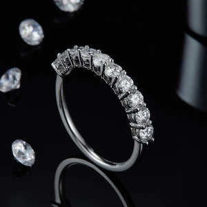 Macro shot of silver plated 925 silver ring with nine sparkling round stones in claw setting
