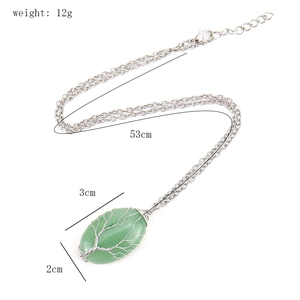 Detailed view of Tree of Life pendant with green natural stone and silver wire wrap