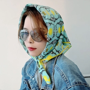 Close-up of light blue patterned sports headband worn by a model in a fashion style