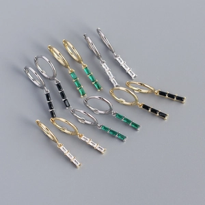 Macro shot of geometric rectangular zircon drop earrings in gold and silver plating