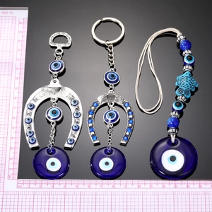 Ethnic tribal style horseshoe evil eye charms with blue glass beads and metal pendant