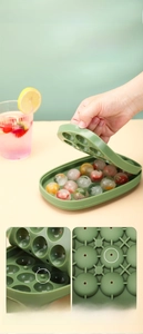 Detail of green ice box mold featuring handle lid, snap closure and drainage holes