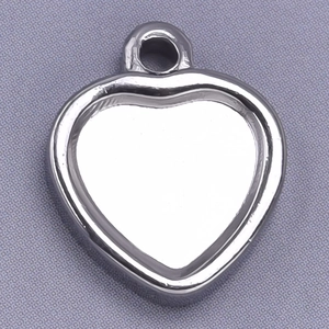 Macro shot of silver heart-shaped stainless steel pendant base for DIY jewelry making