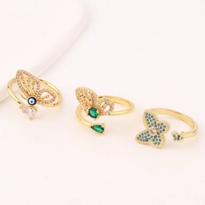 Detail view of butterfly rings set with cubic zirconia stones in golden finish