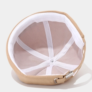 Internal view of khaki cotton docker hat showing sweatband and adjustable metal buckle