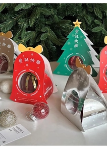 Creative Christmas tree and bell shaped gift boxes on white tabletop with festive decor
