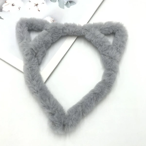 Detailed close-up of fluffy grey plush cat ear headband on a minimalist white background