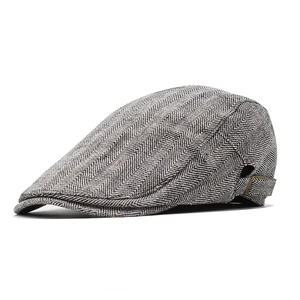 Classic herringbone flat cap in black and white with side adjustable buckle detail