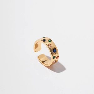 Detailed top view of gold bow ring with colorful inlaid zircons and star-shaped blue gems