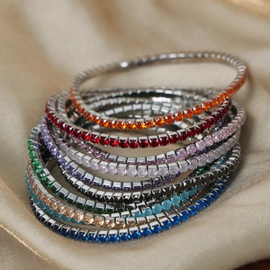 Stack of colorful crystal stretch bracelets with gold plating for women and girls