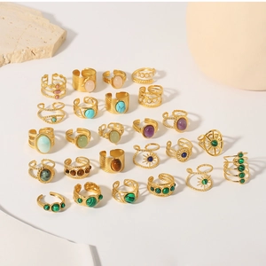 Close-up of assorted vintage 18k gold plated stainless steel rings with colorful natural stones