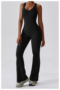 Full view of black V-neck flared yoga jumpsuit showing slimming fit and leg-lengthening silhouette