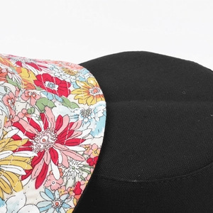 Detail of floral pattern brim and parallel quilting seams on a cotton bucket hat