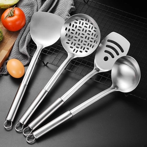 Modern 4-piece stainless steel utensil set with oval handles displayed on a drying rack