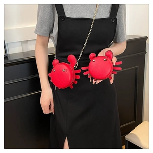 Red crab crossbody bag and coin purse set with gold chain strap shown on model