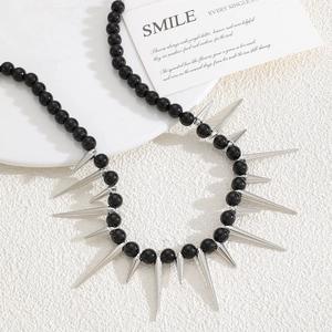 Detail of punk style gothic choker with black beads and sharp metallic silver spikes