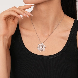 Elegant silver zircon rose flower necklace on model wearing a black ribbed top