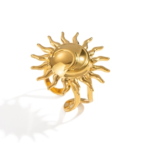 Detail shot of a golden sun-shaped ring featuring a polished radiating metal texture