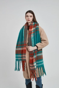 Detail view of colorful checkered scarf with long fringe showing peacock blue and red patterns