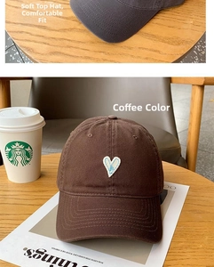 Detail of embroidered white heart and letter A on soft cotton twill baseball caps