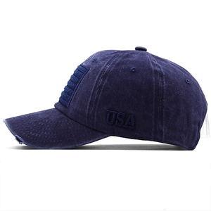 Detail of USA embroidery and distressed brim on navy blue washed cotton baseball cap