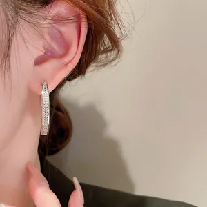 Minimalist geometric circle hoop earrings with sparkling white cubic zirconia on a model