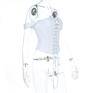 Detailed side view of white corset top with metal eyelets and adjustable lacing