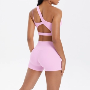 Pink one-shoulder yoga bra and high-waist shorts set shown from the back perspective