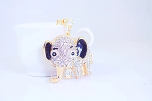 Close-up of golden elephant keychain with sparkling rhinestones and blue enamel details