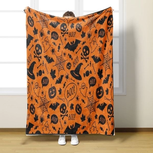 Detail of Halloween flannel blanket featuring pumpkin ghosts and BOO text in orange and black