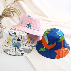 Detailed close-up of colorful kids bucket hats with dinosaur and cactus patterns