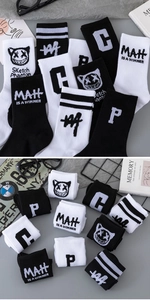 Detail of knit sports crew socks with graffiti face patterns and ribbed textures
