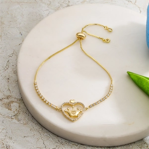 Detail view of gold adjustable heart crown bracelet with sparkling zircon stones