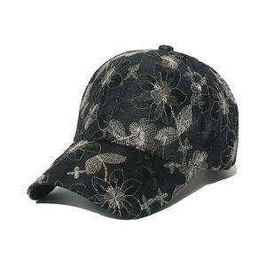 Black baseball cap with silver flower embroidery and detailed floral patterns