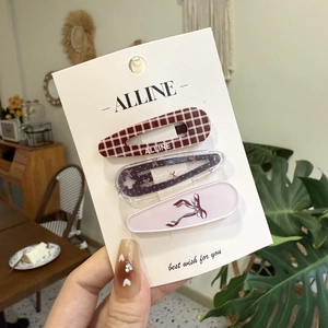 Pink bow and brown plaid hair clip set of three on a minimalist branded display card